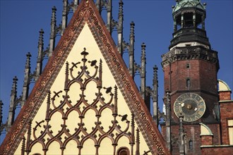 Poland, Wroclaw, part view of the decorative gable of the Town Hall with the clock tower of the