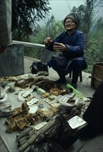 China, Sichuan Province, Mount Emei, Elderly man selling traditional Chinese medicines, using