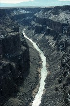 USA, New Mexico, Rio Grande River, View along river near Taos showing deeply eroded banks and bed