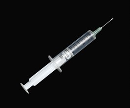 Health, Medicine, Medical Equipment, Hypodermic syringe for giving injections on a black background