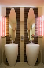 GERMANY, Saxony, Dresden, Washroom in restaurant with two washbasin sinks and matching mirrors.