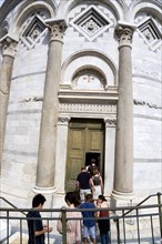 ITALY, Tuscany, Pisa, The Campo dei Miracoli or Field of Miracles with a tour party of tourists at