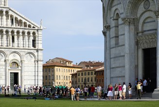 ITALY, Tuscany, Pisa, The Campo dei Miracoli or Field of Miracles.Touists on the grass between the