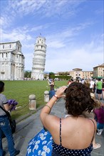 ITALY, Tuscany, Pisa, The Campo dei Miracoli or Field of Miracles.Tourists taking photopraphs of