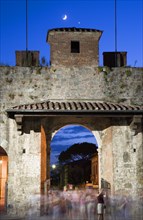 ITALY, Tuscany, Pisa, The Campo dei Miracoli or Field of Miracles.The west entrance gate at dusk