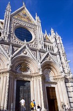 ITALY, Tuscany, Siena, The pink  black and white marble facade of the Duomo cathedral church of