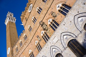 ITALY, Tuscan, Siena, The Torre del Mangia campanile belltower and facade of the Palazzo Publico