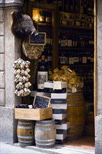 ITALY, Tuscany, Siena, Shop doorway display of Chianti wines and pasta with a stuffed wild boar