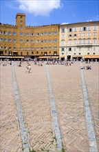 ITALY, Tuscany, Siena, The Piazza del Campo and surrounding buildings with tourists walking in the