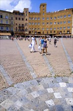 ITALY, Tuscany, Siena, The Piazza del Campo and surrounding buildings with tourists walking in the