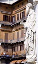 ITALY, Tuscany, Siena, Religious carving at the entrance to the Palazzo Publico in the Piazza del