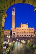 ITALY, Tuscany, Siena, The Torre del Mangia campanile belltower of the Palazzo Publico illuminated