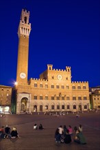 ITALY, Tuscany, Siena, The Torre del Mangia campanile belltower of the Palazzo Publico illuminated