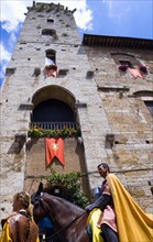 ITALY, Tuscany, San Gimignano, Medieval costumed procession pageant through the streets passing in