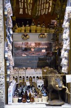 ITALY, Tuscany, San Gimignano, Shop display of chianti wines and wild boar products with a stuffed