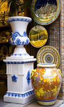 ITALY, Tuscany, San Gimignano, Colourful glazed local ceramics displayed in a shop doorway.