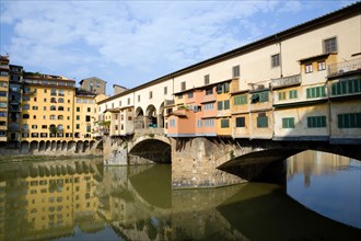 ITALY Tuscany Florence Ponte Vecchio medieval bridge across River Arno with view of merchant's