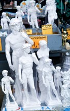 ITALY, Tuscany, Florence, Plaster souvenir statues of David by Michelangelo on a street stall.