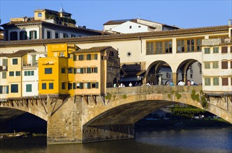 ITALY, Tuscany, Florence, Ponte Vecchio medieval bridge across River Arno with sightseeing tourists