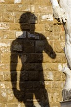 ITALY, Tuscany, Florence, Shadow of the replica Rennaisance statue of David by Michelangelo on the