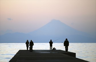 Japan, Honshu, Chiba, Tateyama,  sightseers and fisherman on pier, across Tokyo Bay Mount Fuji
