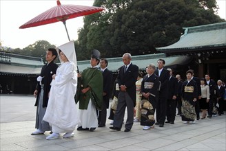 Japan, Tokyo, Yoyogi - at Meiji Jingu shrine, a wedding party in procession, bride in traditional