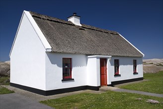 IRELAND, County Donegal , The Rosses Cruit Island, Holiday cottage with thatched roof.