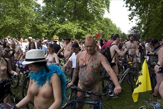 ENGLAND, London, Hyde Park, people with their bicycles, gathered together under the shade of the