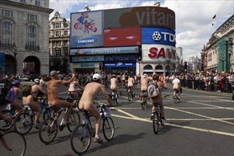 ENGLAND, London, Picadilly Circus, Naked people riding their bicycles while participating at the