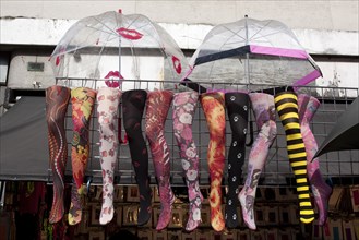 ENGLAND, London, Camden Town, Fake legs with colorful tights and open umbrellas above them, hanged