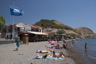 GREECE, North East Aegean, Lesvos Island, Eresos, View of beach with people sunbathing and swimming