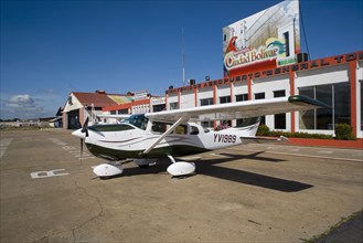 VENEZUELA, Bolivar State, Ciudad Bolivar, Airport with Cessna airplane parked outside the main