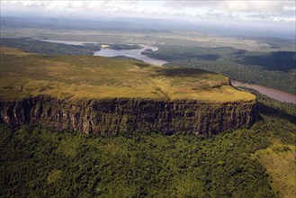 VENEZUELA, Bolivar State, Canaima National Park, Tepui mountain surrounded by a forest and a river