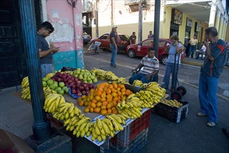 VENEZUELA, Bolivar State, Ciudad Bolivar, Fruit stall with bananas, oranges, apples and other
