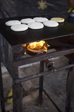 VENEZUELA, Bolivar State, Ciudad Bolivar, Handmade pancakes on a metal big plate with fire