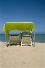 VENEZUELA, Margarita Island, Playa Caribe, View of a green tent at the Playa Caribe beach with a