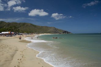 VENEZUELA, Margarita Island, Playa Caribe, View of exotic beach with people swimming and walking on
