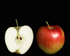 Food, Fruit, Apples, Two ripe red apples with one whole and one cut in half to show the core seeds