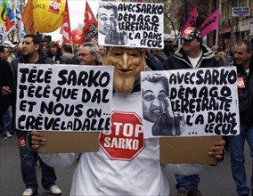 France, Paris, Rue de Faubourg Saint Antoine, A Nicolas-Sarkozy masked protestor marches down the
