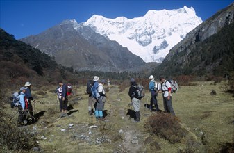 BHUTAN, Snowman Trek, Group of travellers hiking on a trail near Limithang beneath Mount Gangcheta