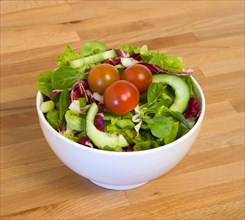 Food, Vegetables, Salad, White bowl of green leaf salad with tomatoes and cucumber on a wooden