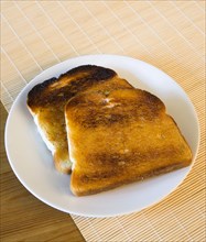 Food, Cooked, Bread, Table setting of two slices of buttered toast on a plate.