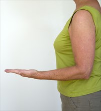 Health, Body, Arms, Woman in profile from side with arm bent at elbow with palm of hand facing