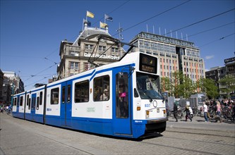 Netherlands, Amsterdam, Tram passing by De Bijenkorf department store in Dam 1.