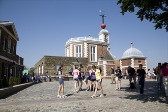 England, London, Greenwich Royal Observatory, shchool girls walking on the Meridian line in the