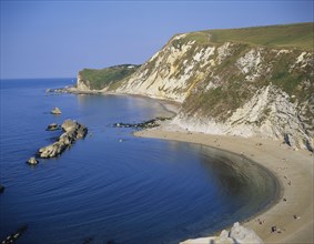 England, Dorset, Typical rocky coastline and sandy bay.