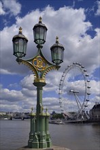 England, London, Westminster, London Eye framed with lamp post on Westminster Bridge.