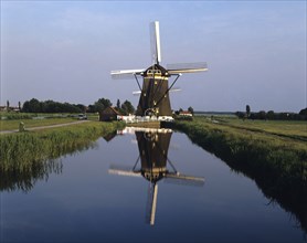 Holland, Wilsveen Windmill reflected in canal.