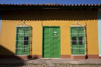 Cuba, Sancti Spiritus, Trinidad, Traditional colourfully house with orange painted walls and green
