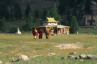 Mongolia, Kentii province, Baldan Baraivan, Monks walking through fields towards the temple.